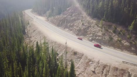 Chasing-shot-of-a-red-car-through-Colorado-mountains-in-4k