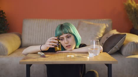 troubled young woman looking at knife and pills in front of her.