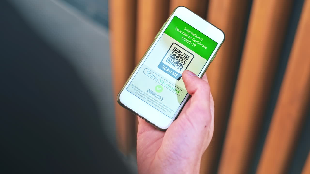 Pomeranian with yellow fur sitting on the snow and rising paw on the backyard. Snowflakes falling on it