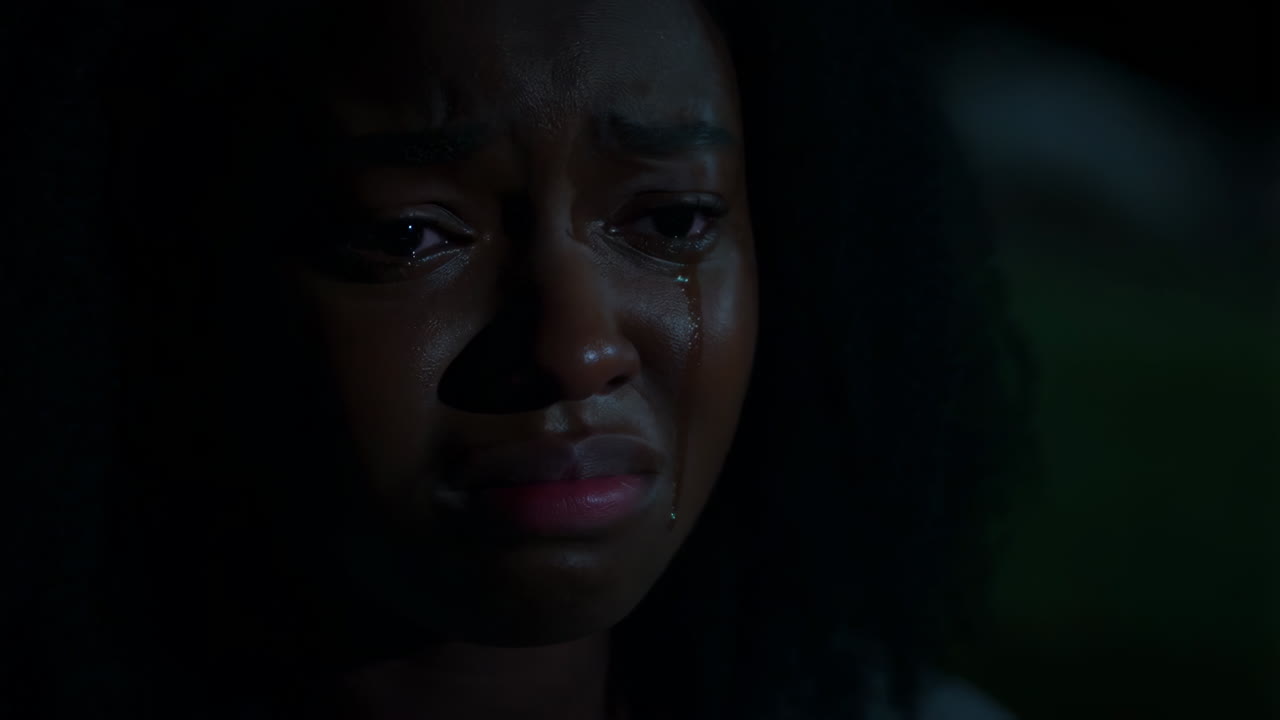 Close-up of a Person Crying in Dim Light