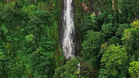 aerial view of a drone approaching a waterfall
