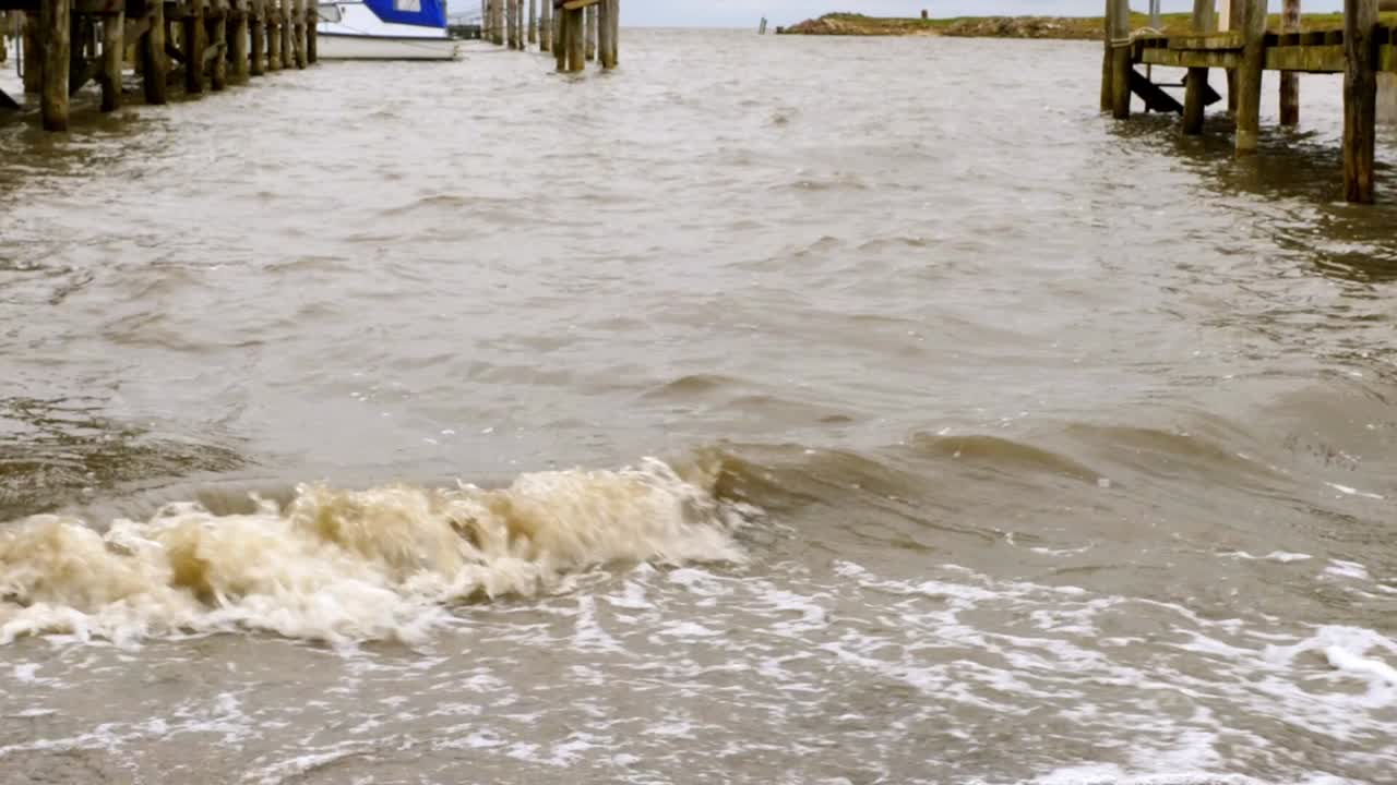 Close -up of waves hitting the pier of a small harbor in Rantum, Sylt