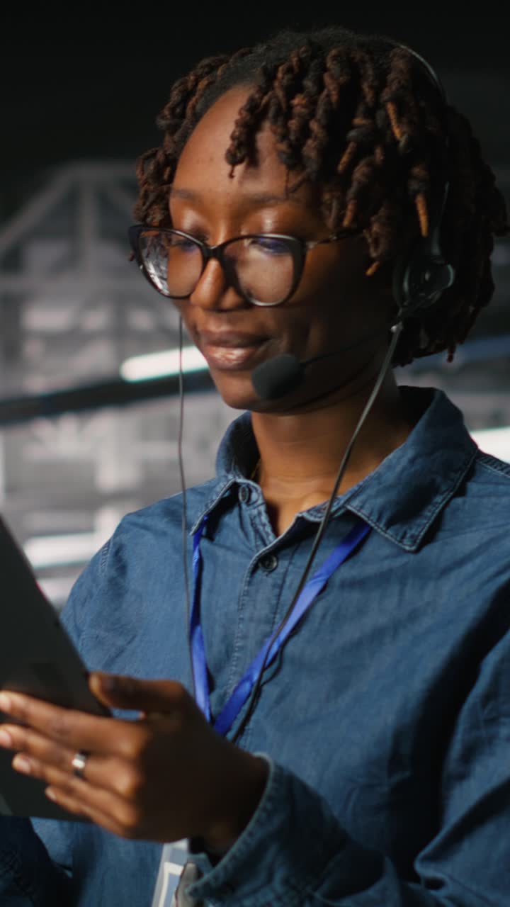 Vertical video Server room admin uses tablet and headset to provide ...