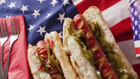 video of hot dogs with mustard and ketchup over flag of usa