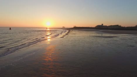 Aerial:-The-boulevard,-beach-and-city-of-Vlissingen-during-sunset