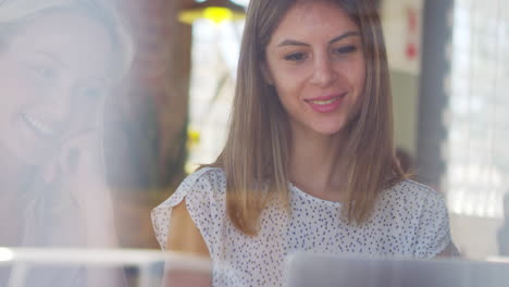 Three-Businesswomen-Meeting-In-Coffee-Shop-Shot-Through-Window