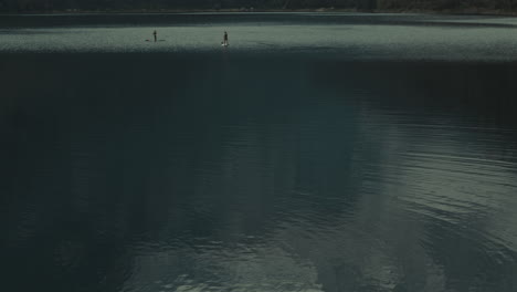 couple stand up paddle in gosausee lake