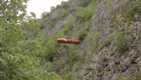 emergency stretcher transported with ropes above a canyon rescuing an injured person