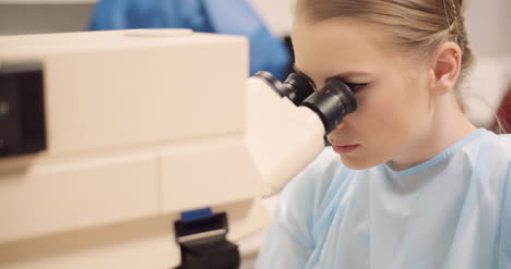 scientist examining bacteria under microscope at laboratory 5