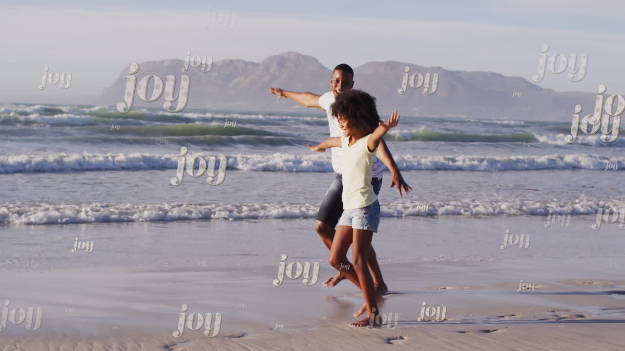 크리스마스 축하 문자 아프리카계 미국인 아버지와 딸이 해변에서