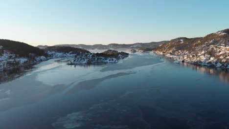 calm freezing water of strait near kragerø on a sunny winter day in norway