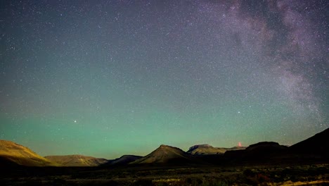 time lapse of stars and milky way over karoo landscape with a transmission tower with red lights in background