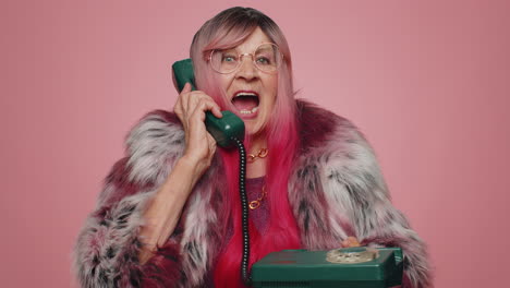 Cheerful-tourist-woman-secretary-talking-on-wired-vintage-telephone-of-80s-says-hey-you-call-me-back