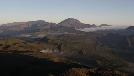 A-fly-over-the-plains-and-mountains-of-Reunion-Island-with-a-view-of-Piton-des-Neiges