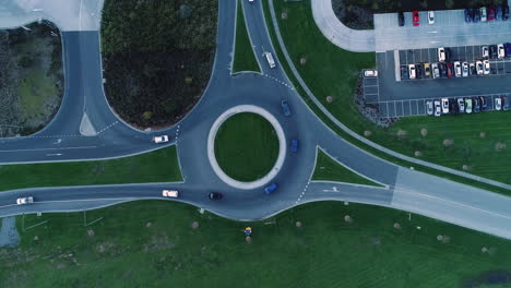 Hyperlapse-of-cars-and-trucks-moving-around-a-round-about-before-embarking-on-their-journey