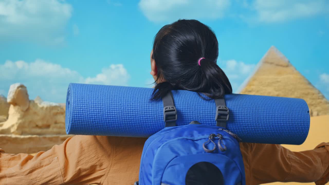 Close Up Back View Of A Female Hiker With Mountaineering Backpack Spreading Arms And Looking The View Around While Traveling In Pyramid Of Giza