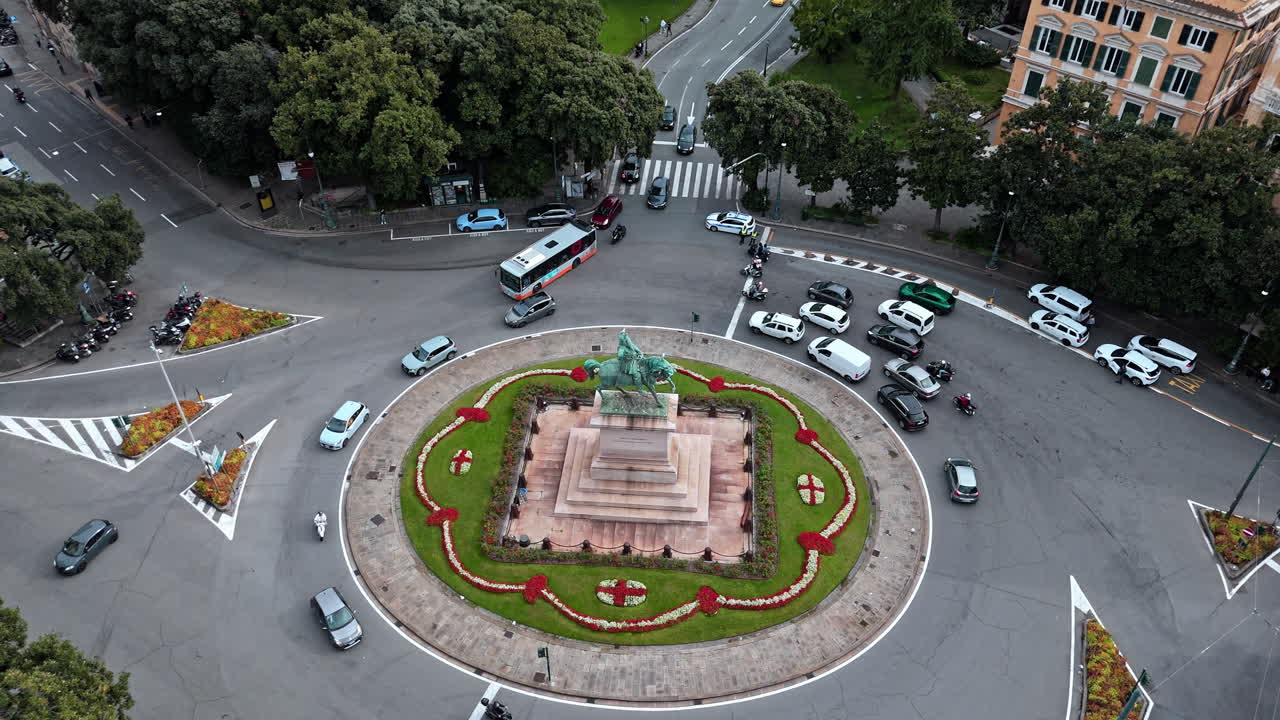 Piazza Corvetto in central Genoa with traffic around equestrian statue, aerial