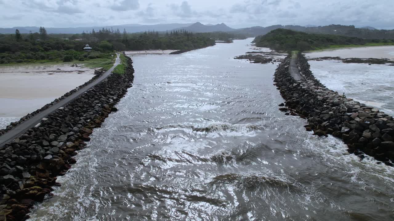 Stone Breakwalls And Torakina Beach On The Mouth Of Brunswick River In New South Wales, Australia. wide aerial shot