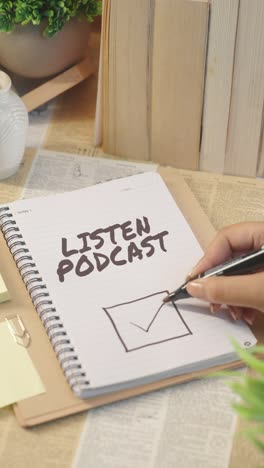 vertical video of ticking off listen podcast from checklist