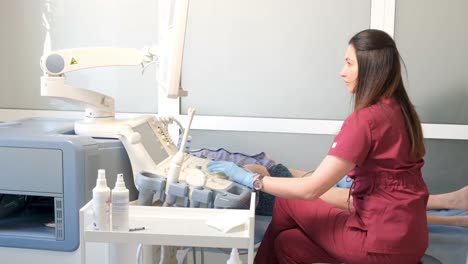 close-up of the hands of an ultrasound doctor performing an ultrasound of the abdominal cavity on a patient with a modern scanner. modern medical diagnostic equipment. vertical video.