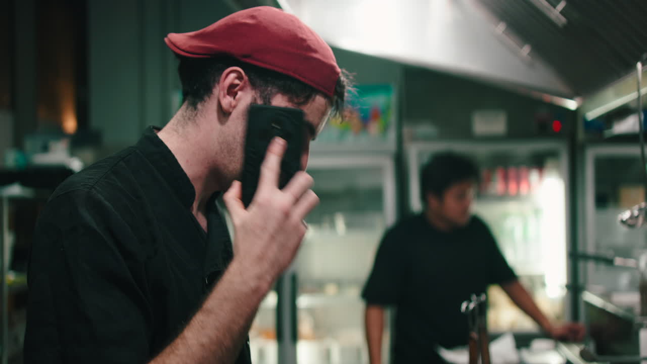 Chef on the phone in a restaurant kitchen