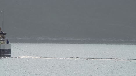 commercial fishing trawler laying the fishing net in the water