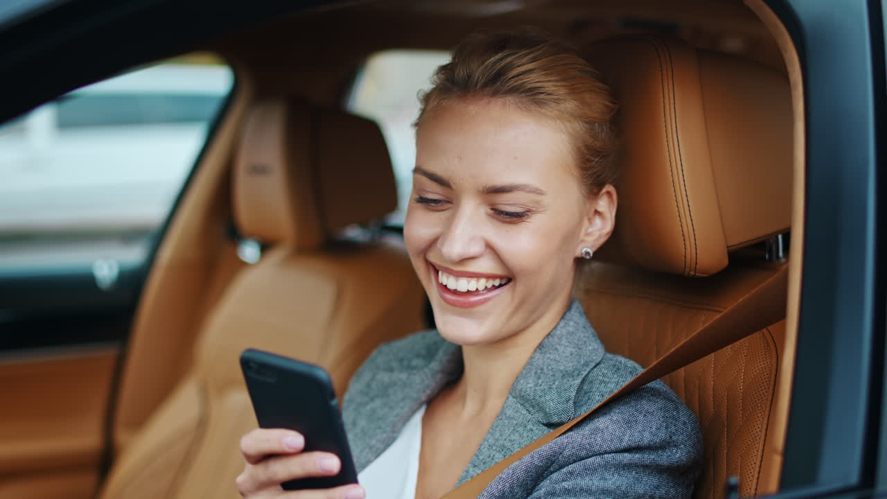 Businesswoman using smartphone at car