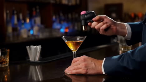 bartender creating a smoked cocktail with dry ice at a bar