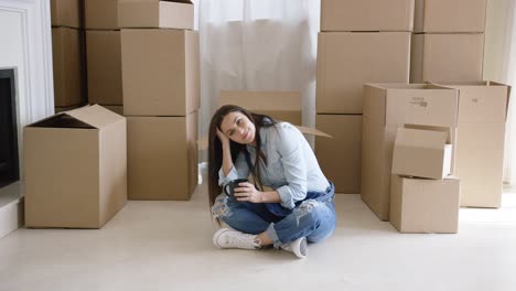 Tired-young-woman-taking-a-break-from-moving-house