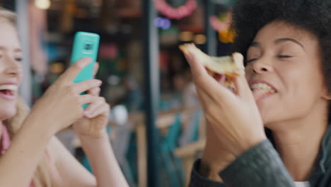 best friends eating pizza at restaurant woman using smartphone taking photo of friend enjoying meal two women having fun sharing weekend together on social media 4k