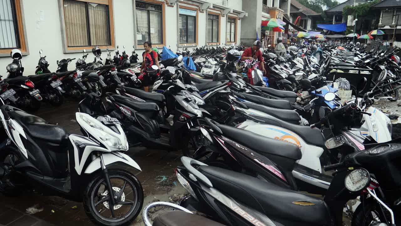 Clip of a busy scooter parking area in Bali Indonesia.