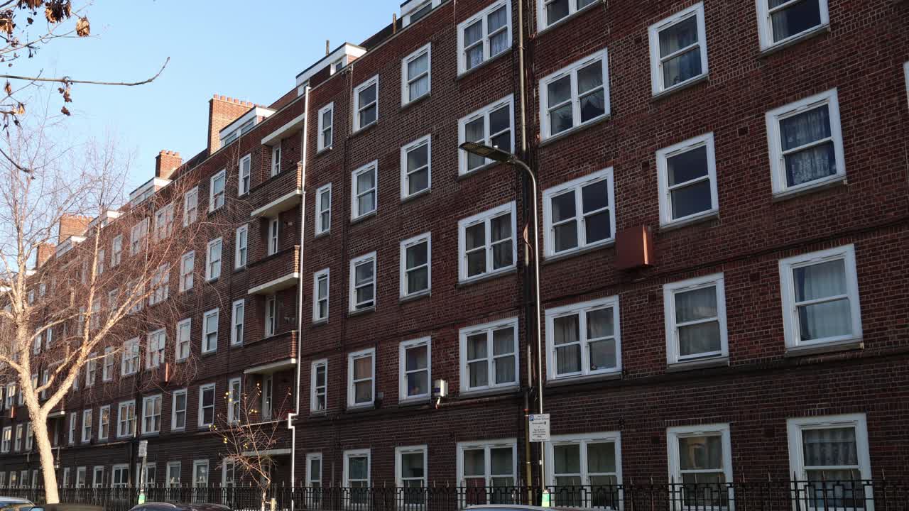 Multi apartment red brick residential building, establisher background