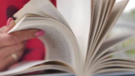 Woman&#039;s hands flipping through a book