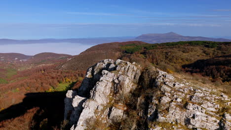 stunning aerial view of autumn mountains with rocky ridge and valley fog