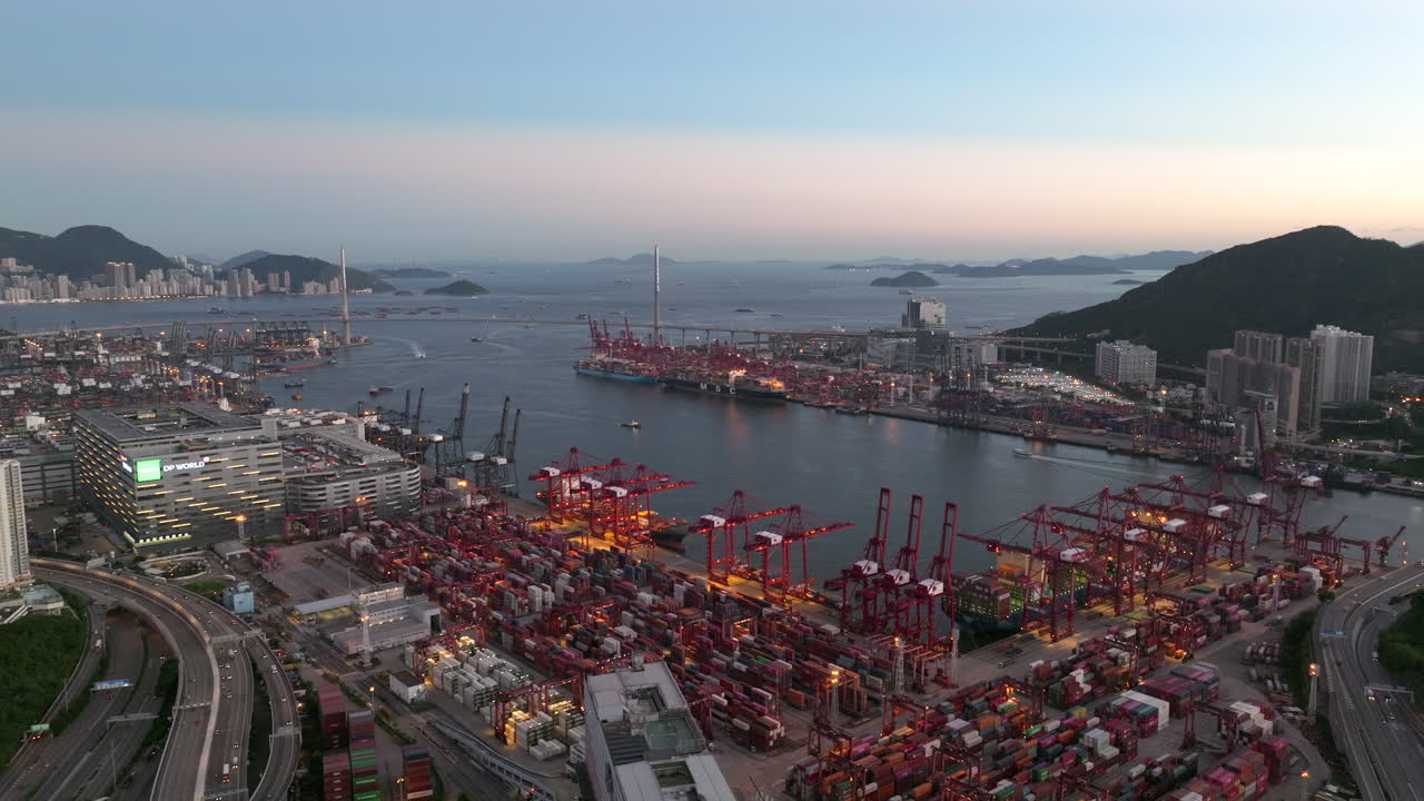 Giant container port illuminated by terminal lights after sunset on a clear day