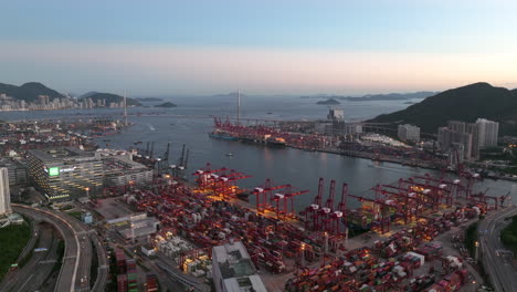 giant container port illuminated by terminal lights after sunset on a clear day