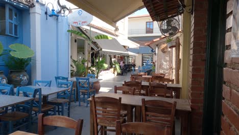 beautiful greek street scene, restaurant esplanades in a picturesque alley, preveza