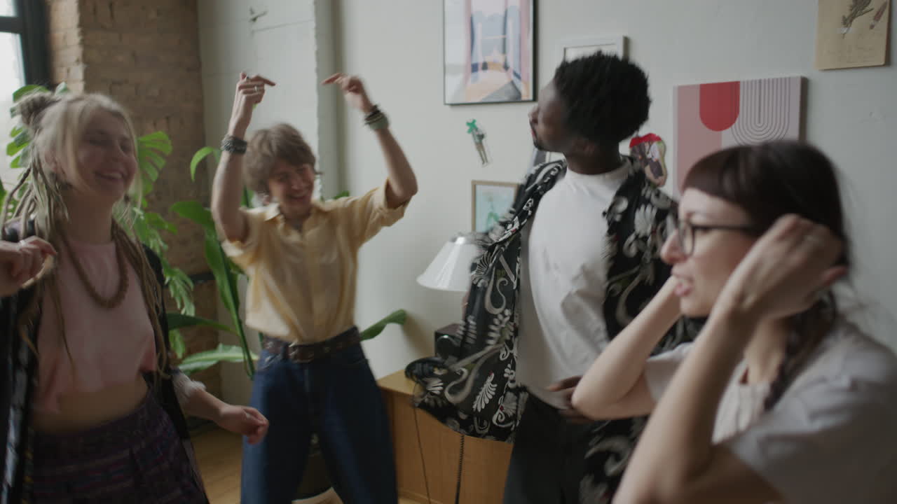 Diverse Group of Friends Dancing with Joy near Vinyl Record Player at Home