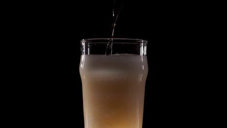 Beer-on-black-background-poured-with-a-lot-of-head-in-slow-motion