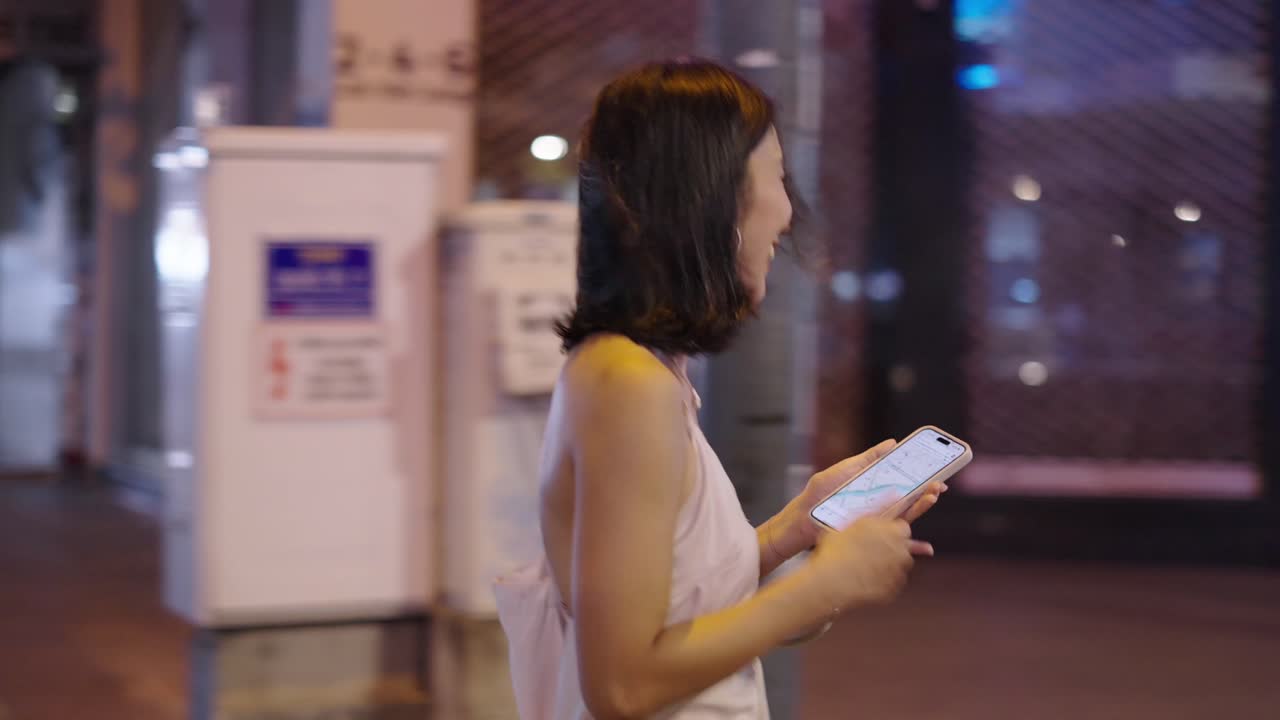 Woman Walking at Night in a City