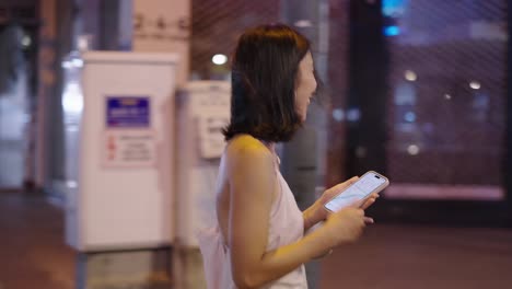 woman walking at night in a city