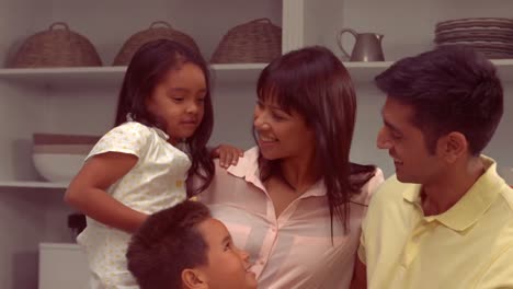 smiling hispanic family in the kitchen