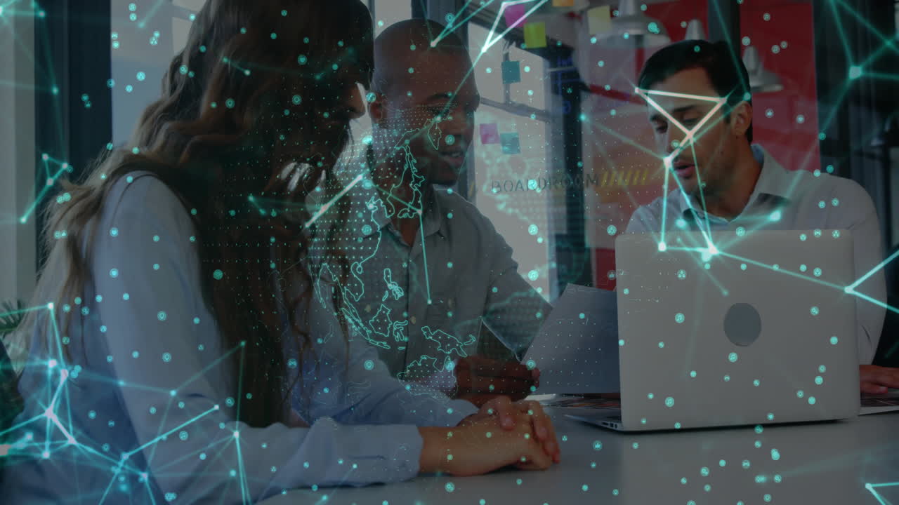 Animation of network of connections over diverse business people using laptop in office