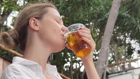 woman enjoying a drink outdoors