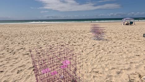 art installation on sandy beach with ocean backdrop