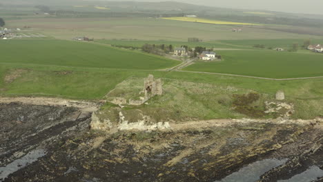 an aerial view of newark castle on the fife coastal path, scotland