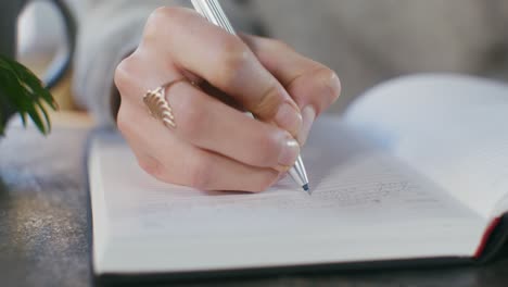 person writing in a notebook