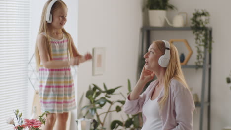 mother and daughter dancing in kitchen