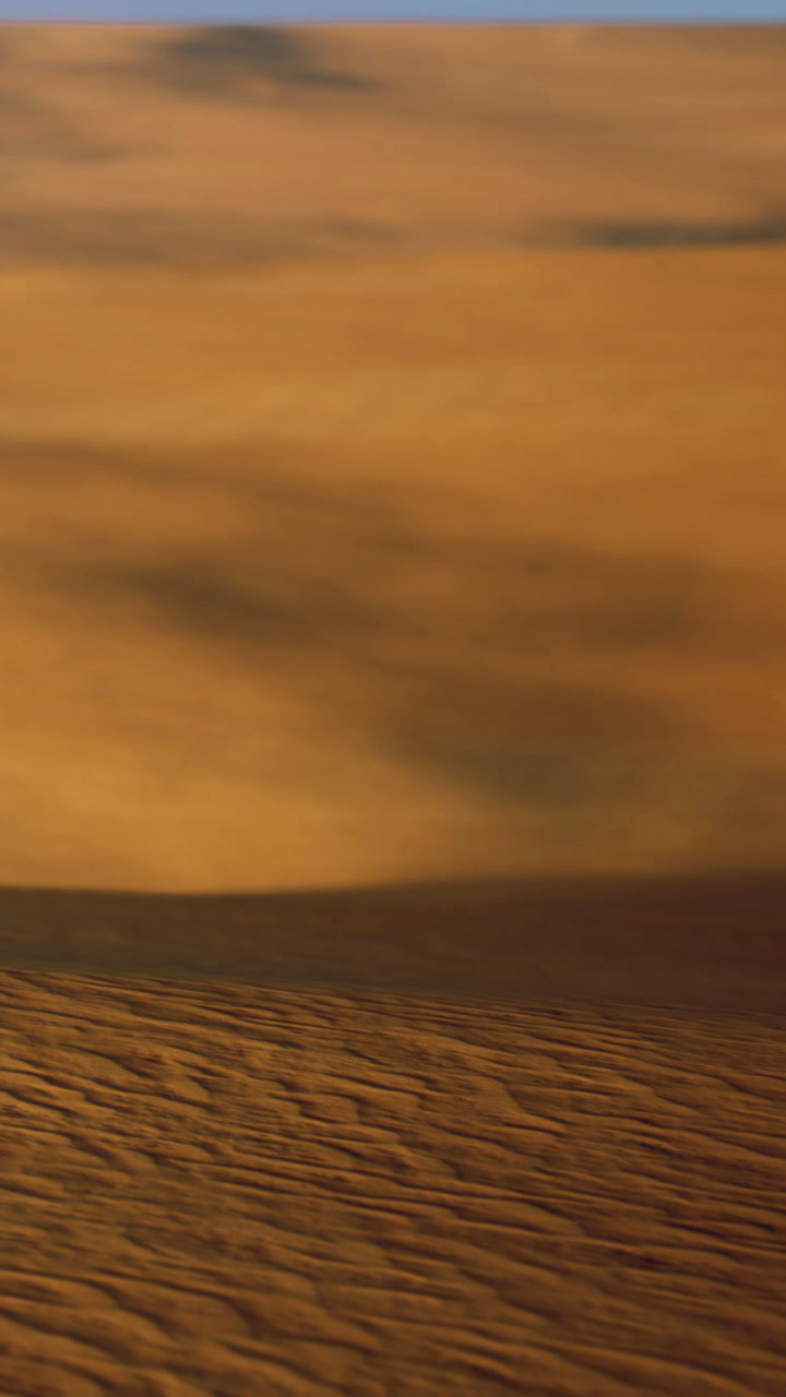 Calming waves dance softly over a tranquil sandy shore at sunset