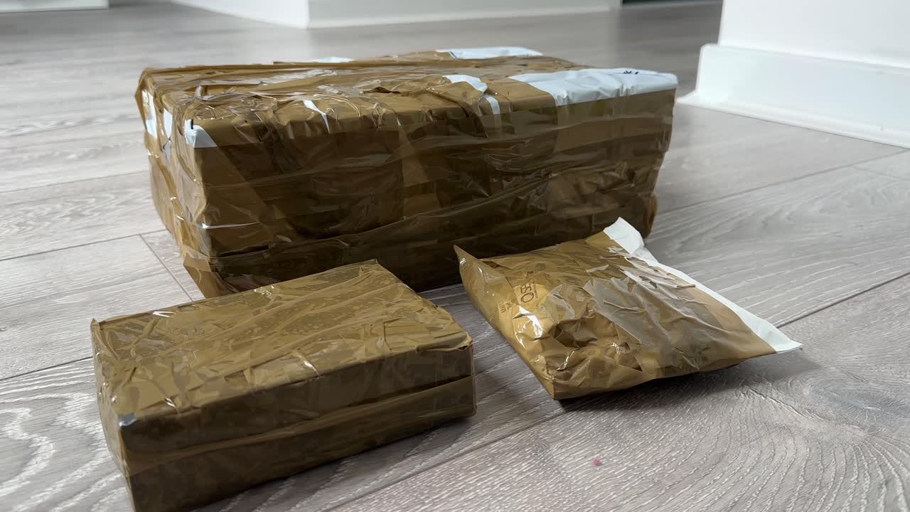 Ebay parcels wrapped Close Up of Cardboard Packages Wrapped with Duct Tape for Shipping and Delivery